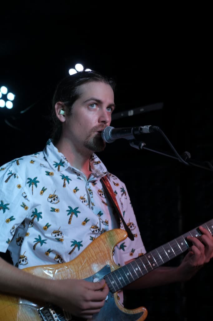 Luke Moore singing live vocals into microphone